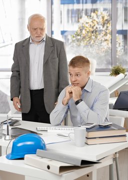 Scared office worker with angry executive