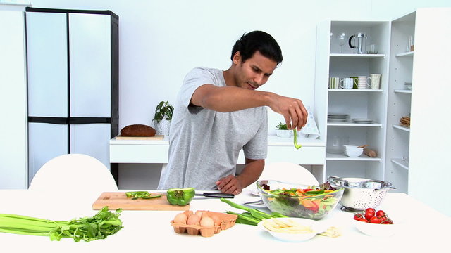 Man preparing a salad for lunch