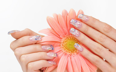 Fingernails with sparkle manicure and pink flower