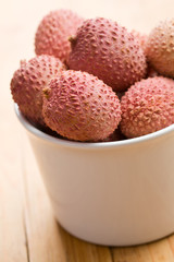 tasty litchi fruit in ceramic bowl