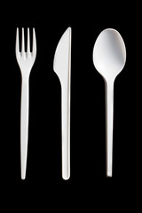 plastic cutlery on black background