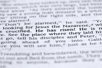 Open Bible with focus on text in Mark 16:6: "He has risen"