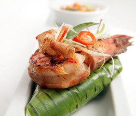 grilled prawn on fried rice wrapped in banana leaf