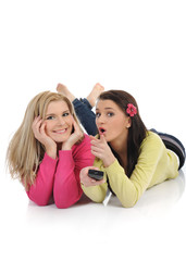 expressions.two young pretty woman friends watching television a