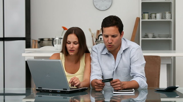 Happy couple looking at their accounts online
