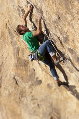 Climber clinging to a cliff.