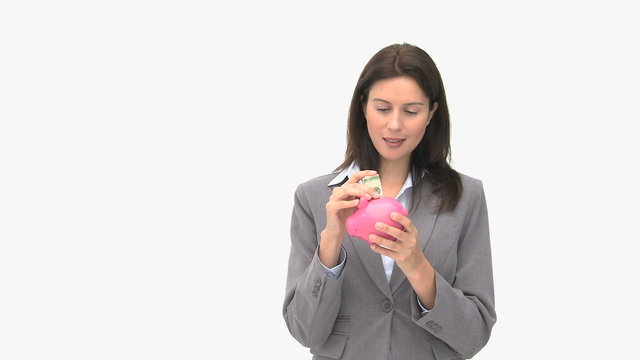 Happy businesswoman saving money in a piggybank