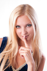 Naklejka premium Beautiful girl holding a finger near the lips
