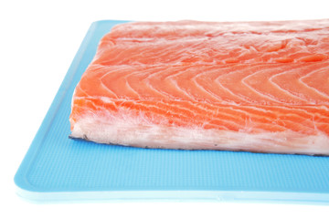 raw salmon fillet on blue plate