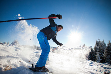 Man practicing extreme ski on sunny day