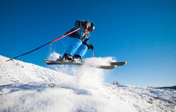 Man practicing extreme ski on sunny day