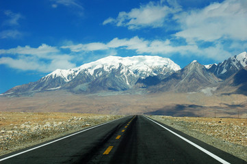 Highway towards snow mountains