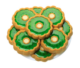 Cookies with green jelly on white plate, isolated