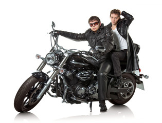 Couple in a black leather sitting on black custom motorcycle