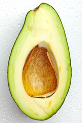 Ripe avocado with drops of water