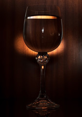 Glass of water on the black wooden background