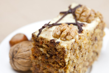 Piece of cake with nuts lying on the plate