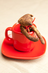 Teddy bear handmade in a cup and nuts