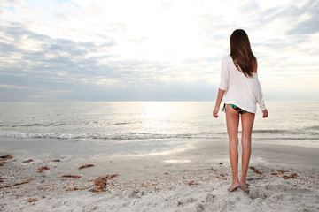 Girl enjoys summer day at the beach.