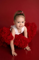 Adorable little girl in red pettiskirt tutu