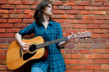 Young Brunette Female  Playing Guitar