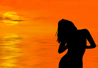 Silhouette of a  woman at sunset