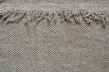Natural linen canvas background with fringe