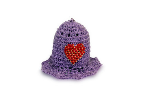 little knitted cap on a white background with a Heart