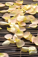 withered rose petals on bamboo mat
