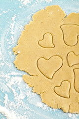 Making heart shaped shortbread cookies with cutters, dough