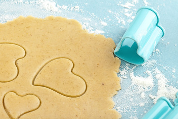 Making heart shaped shortbread cookies with cutters, dough