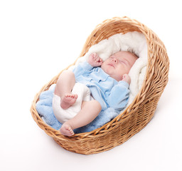 New born baby sleeps in basket