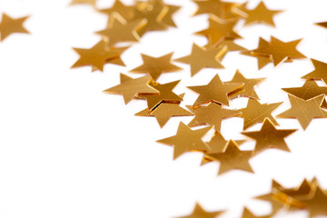 Christmas decoration of golden confetti stars with bokeh