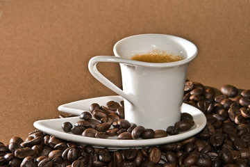 A creamy espresso with a coffe bean