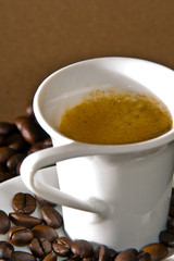 A creamy espresso with a coffe bean