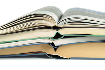 Close-up of a pile of luxury bound open books isolated on white