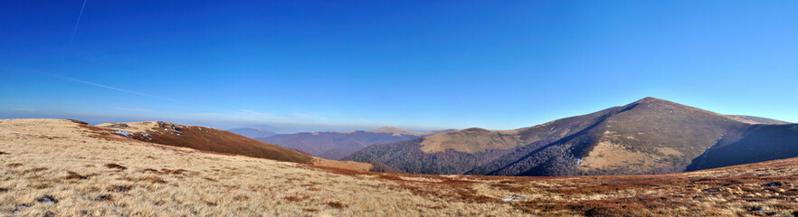 Autumn mountain meadows and peak view