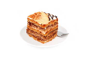 Slice of nut cream cake, isolated on white background