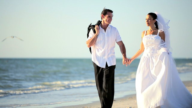 Happy Wedding Couple  Walking the Beach