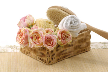 Fototapeta na wymiar Spa essentials (bath accessories and rose petals in basket )
