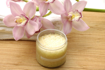 Fototapeta na wymiar Spa essentials (cream, white towel and pink orchids)