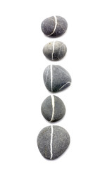 Row of assorted pebbles isolated on a white