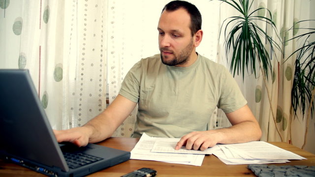 Man calculating his bills