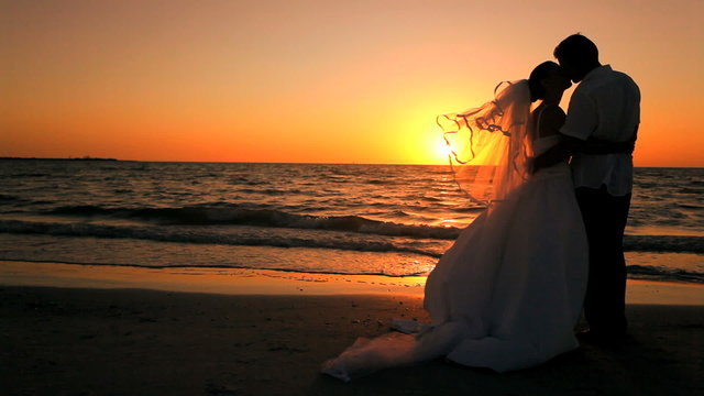 Kiss at Sunset Beach Wedding