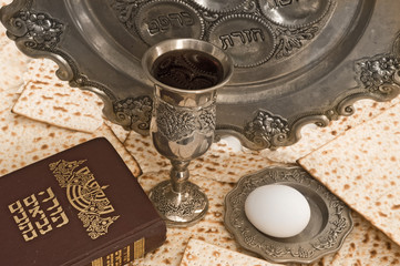matzot, red wine,silver dish  ans torah