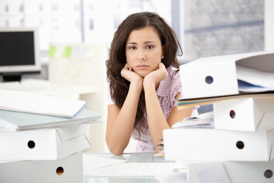 Young office worker sitting troubled in office