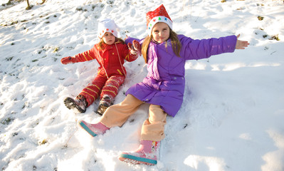 two little girls playing on the snow