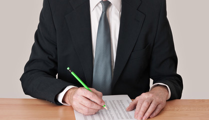Man at desk analysing budget schedule