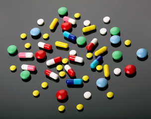 Colorful pills over dark background