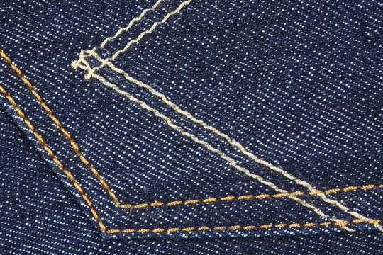 Showing lines and texture of blue jeans, back pocket.